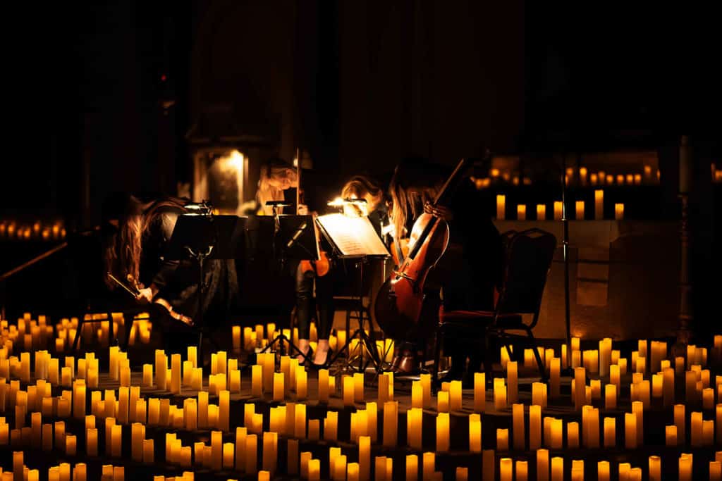 A string quartet play, surrounded by candles, at a Candlelight Concert in St. Andrew's Church, Dublin. 