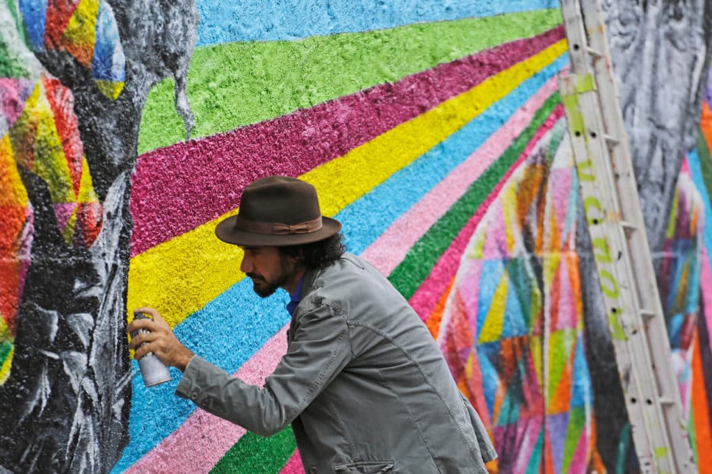 Brazilian artist Eduardo Kobra use a spray to paint a colorful mural in Vila Madalena