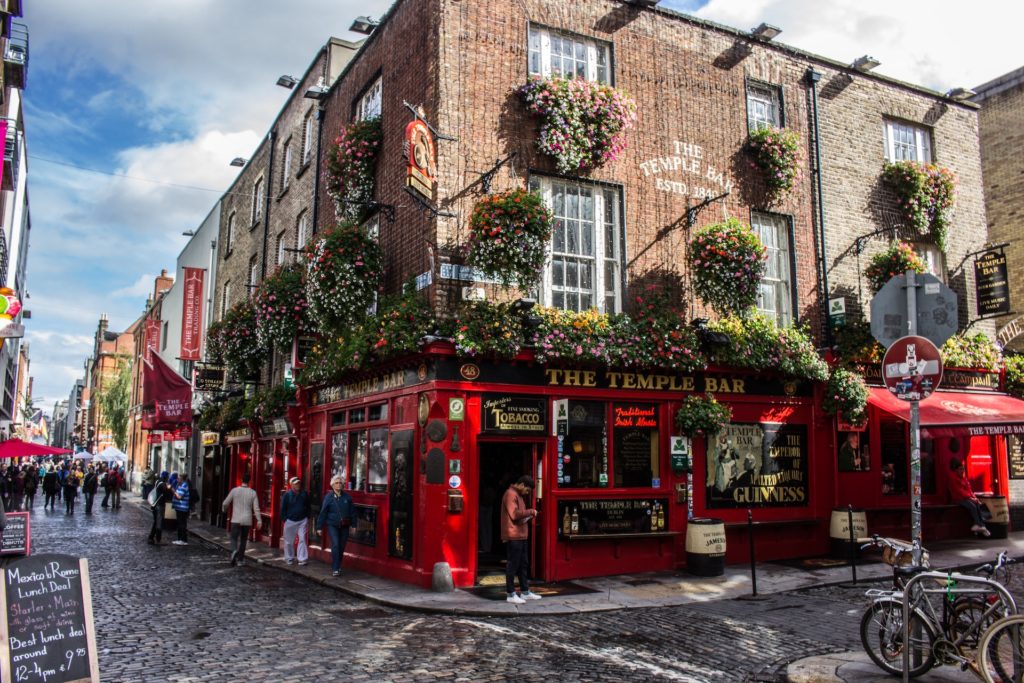 The bright red, leafy facade of The Temple Bar pub in Dublin