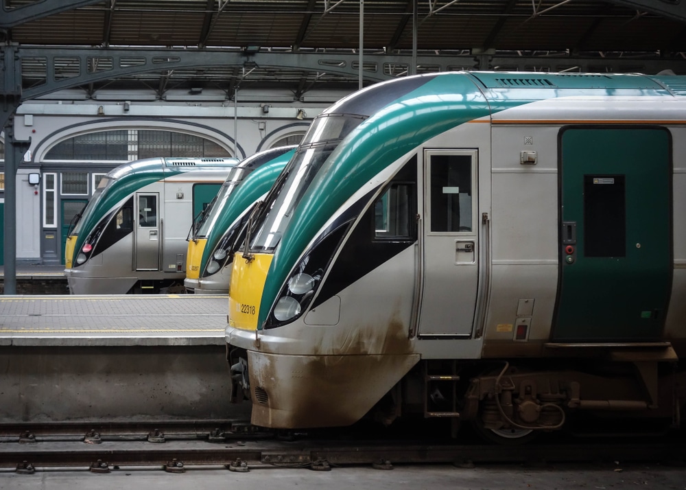 Three Irish rail trains sit in a station in Dublin.