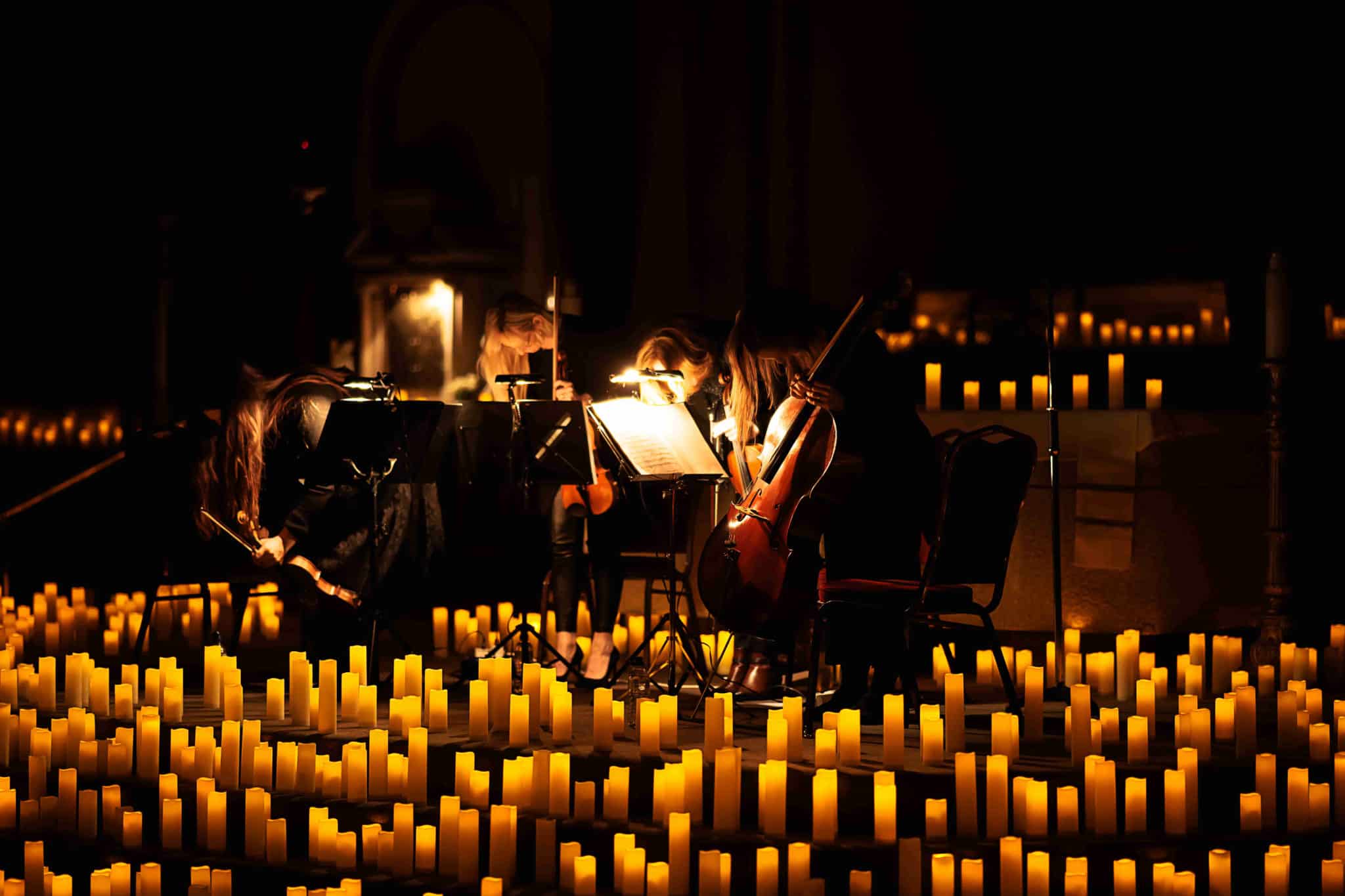 A string quartet play, surrounded by candles in Dublin.