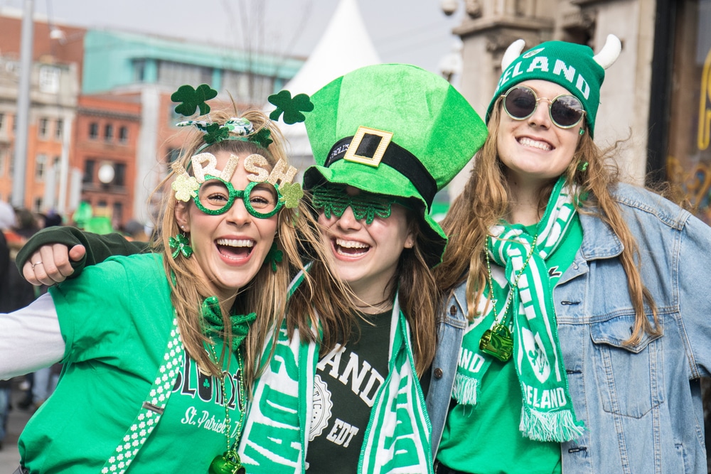 Three women, dressed in green, celebrate the St Patricks Day Festival.