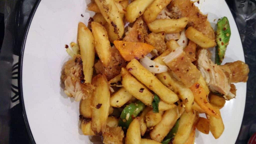 A Dublin spice bag, with chips, peppers, fried chicken and spices.