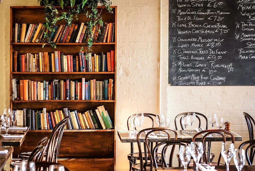 A bookshelf stocked with books in the restaurant areas of Teh Winding Stair in Dublin.